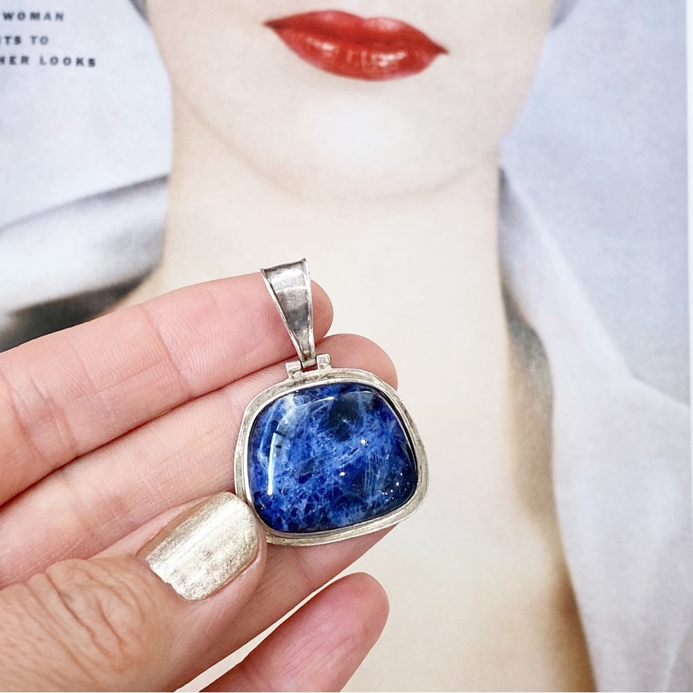 Sterling silver and lapis stone pendant.